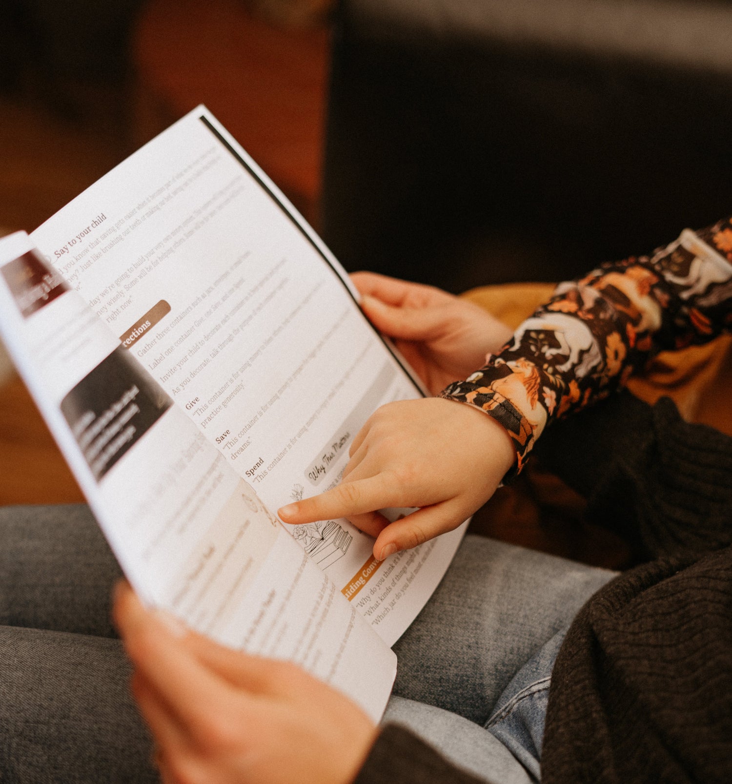 Mother reading Book One to children with a blurred background